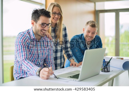 Young designers using laptop in office