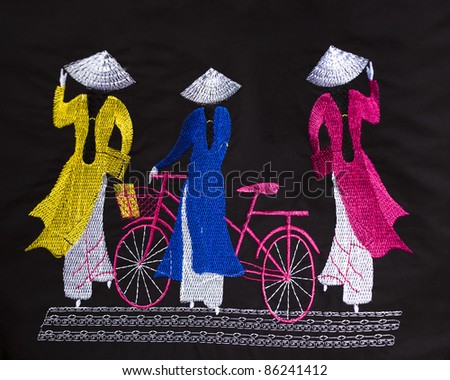 traditional Vietnamese particulars i.e. Ao Dai, hat and bicycle embroidered on a cloth as souvenir available for sale