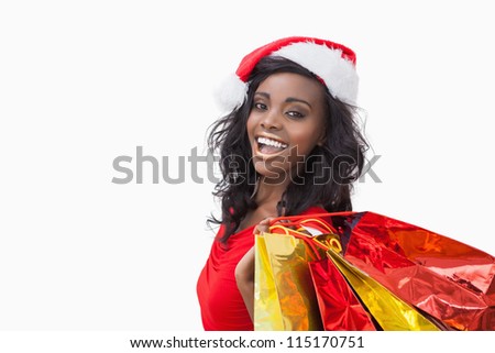 stock-photo-woman-wearing-santa-claus-hat-while-holding-bags-115170751.jpg
