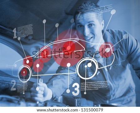 Mechanic reparing car while consulting futuristic interface in blue