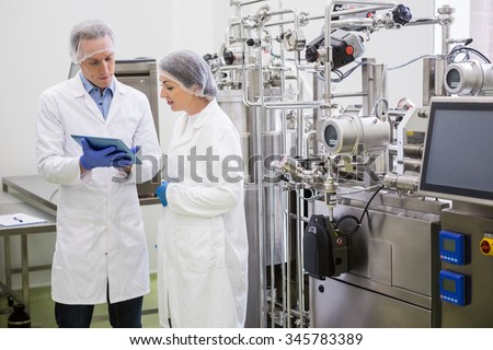 Scientists using tablet to control vats in the lab
