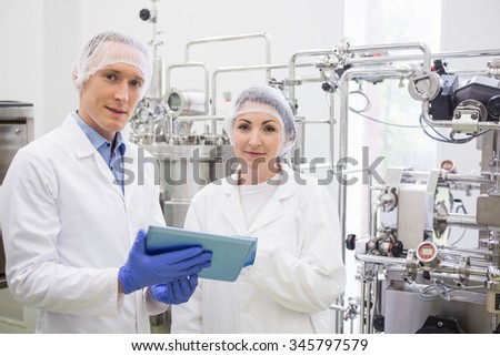 Scientists using tablet to control vats in the lab