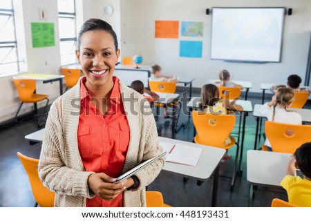 Teacher posing with her tablet at school