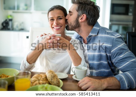 https://thumb7.shutterstock.com/display_pic_with_logo/76219/585413411/stock-photo-man-kissing-on-woman-cheeks-while-having-breakfast-at-home-585413411.jpg