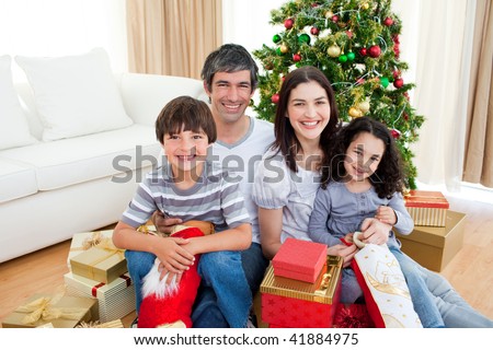 Family Gathered Around Christmas Tree Using Stock Photo 483304177 ...
