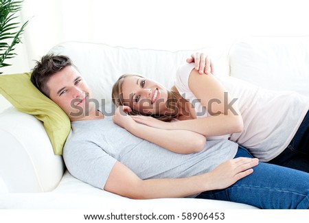 https://thumb7.shutterstock.com/display_pic_with_logo/76219/76219,1280861013,71/stock-photo-enamored-young-couple-lying-together-on-the-sofa-in-the-living-room-58906453.jpg