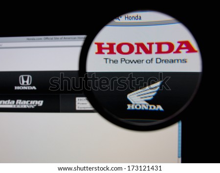 LISBON - JANUARY 26, 2014: Photo of Honda homepage on a monitor screen through a magnifying glass.