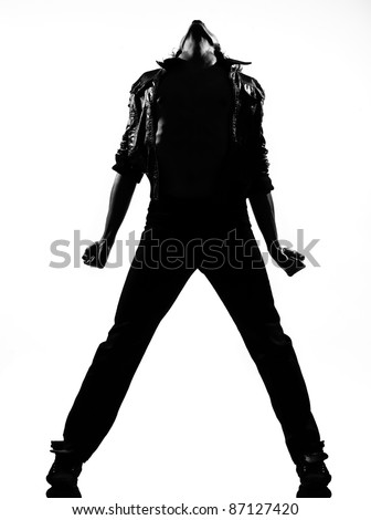 full length silhouette of a young man dancer dancing funky hip hop rb on isolated studio