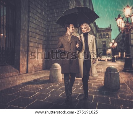 https://thumb7.shutterstock.com/display_pic_with_logo/78238/275191025/stock-photo-elegant-couple-with-umbrella-walking-outdoors-in-the-rain-275191025.jpg