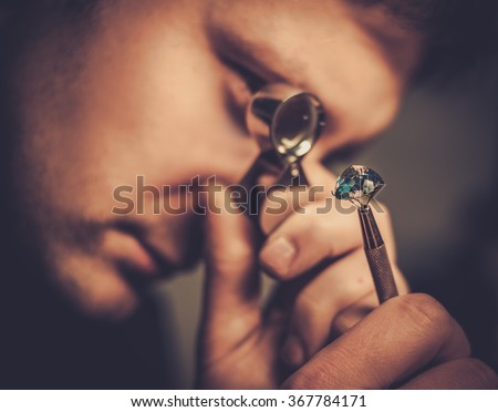 Portrait of a jeweler during the evaluation of jewels.