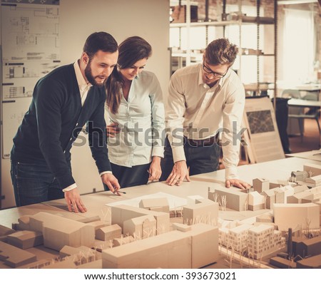 Confident team of engineers working together in a architect studio.