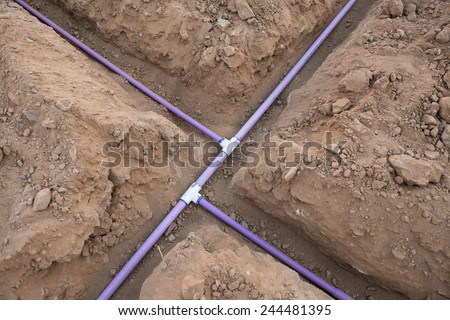 Sprinkler system pipe in dirt trenches for underground irrigation system using reclaimed water.