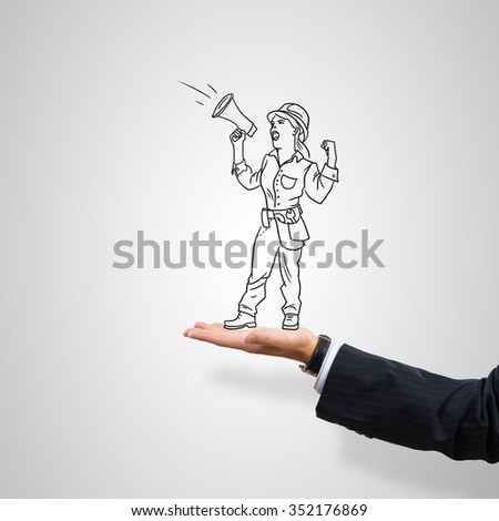 Drawn engineer woman in female palm on gray background