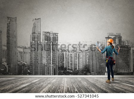 Back view of engineer woman with folder and sketches of construction project on wall