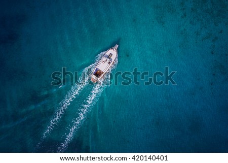 Vintage wooden boat in coral sea. Boat drone photo.