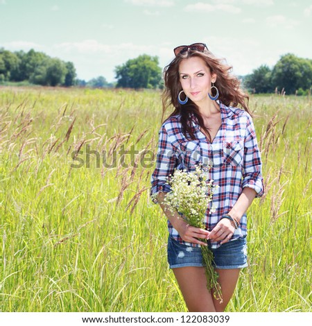 https://thumb7.shutterstock.com/display_pic_with_logo/809509/122083039/stock-photo-young-woman-with-chamomile-bouquet-walking-on-the-field-122083039.jpg
