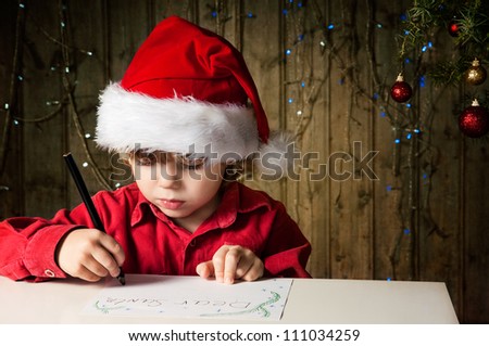 Blond boy writes a letter to Santa