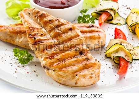 Grilled chicken breasts and vegetables - stock photo