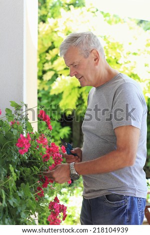 https://thumb7.shutterstock.com/display_pic_with_logo/816064/218104939/stock-photo-portrait-of-casual-old-man-pruning-flowers-218104939.jpg