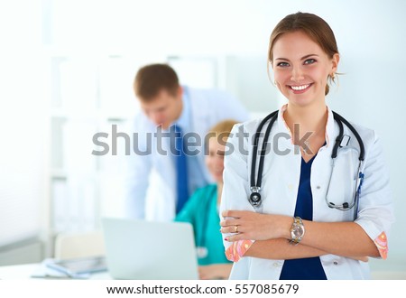 Attractive female doctor in front of medical group