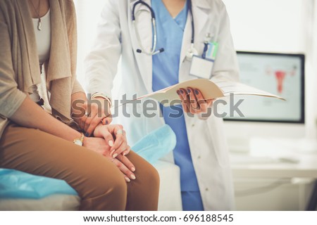 Doctor and patient discussing something while sitting at the table . Medicine and health care concept. Doctor and patient