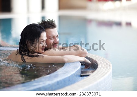 Couple relaxing in jacuzzi of spa center