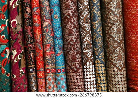 A variety of different bolts of traditional fabric, Colored brocade ...