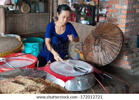 BEN TRE, VIETNAM - MARCH 7: A woman demonstrates how to make rice papers for Vietnamese spring rolls on March 7, 2009 in Ben Tre. Ben Tre in the Mekong delta has become a popular tourist destination.