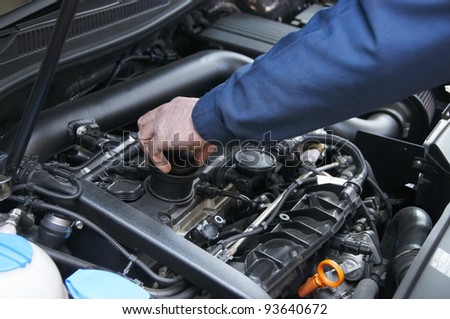 mechanic repairs a car in a garage