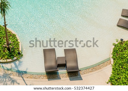 Beach Chairs In Luxury Swimming Pool At Tropical Hotel Resort Relaxing And Leisure Time View Preview Beach Chairs In Luxury Swimming Pool At Tropical Hotel Resort Relaxing And Leisure Time View Preview