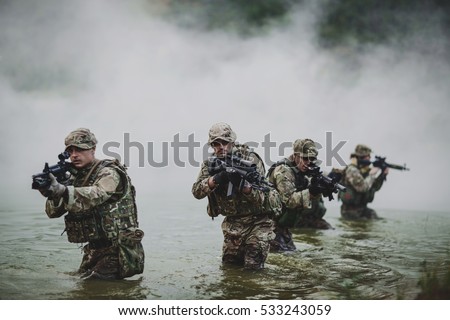 British special forces soldiers with weapon take part in military maneuver. war, army, technology and people concept.