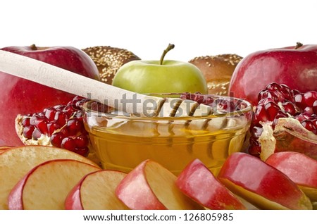 Still life closeup - challah, apples, pomegranate and bowl of honey, isolated over white. Illustration of Rosh Hashanah (jewish new year) or Savior of the Apple Feast Day