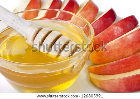 Cut into slices of apples with a bowl of honey, isolated over white. Illustration of Rosh Hashanah (jewish new year) or Savior of the Apple Feast Day