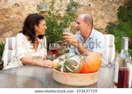 stock photo side portrait of a senior couple relaxing in the garden of a luxury hotel on holiday enjoying a 193637729