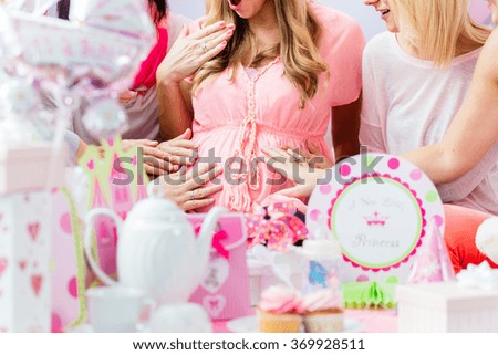 Best Friends on baby shower party celebrating giving kid stuff as present