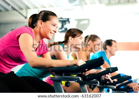 Group of four people in the gym, exercising their legs doing cardio training