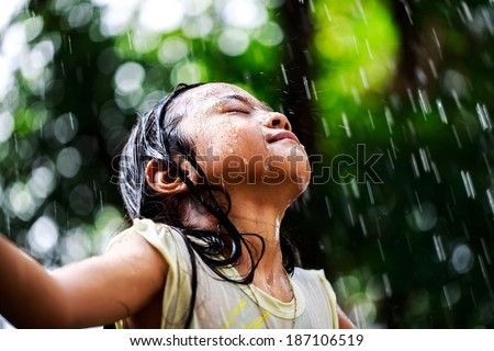 Closeup little girl in the summer rain