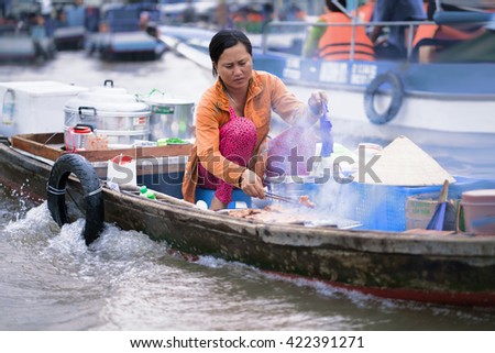 Can Tho, Vietnam - February 28, 2016: Woman cooking food for sale in the floating market in Can Tho in Vietnam.