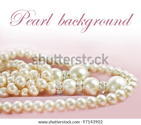 Background with Pearls necklace on pink silk fabric