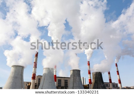 Smoking pipes of thermal power plant against blue sky