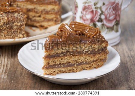 Piece Of Cake With Honey Shortcakes Cream Boiled Condensed Milk And Sprinkle Nuts On Piece Of Cake With Honey Shortcakes Cream Boiled Condensed Milk And Sprinkle Nuts On