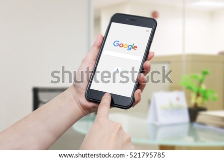 BANGKOK, THAILAND -NOVEMBER 24, 2016. Google app logo display on iphone screen in female hands on November 24,2016 in Thailand. Google just change there logo in September 2015