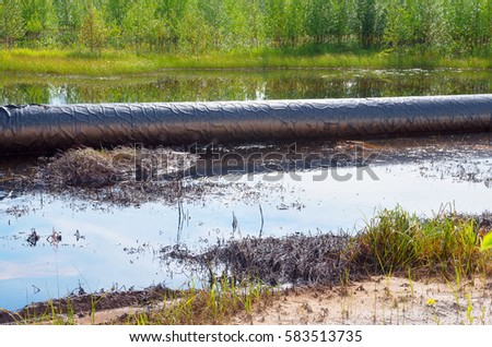 An accident on an oil pipeline. An oil spill around the pipeline.
Environmental pollution.