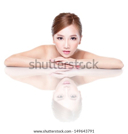Beautiful face skincare beauty woman lying down with mirror reflection isolated on white background. asian beauty model