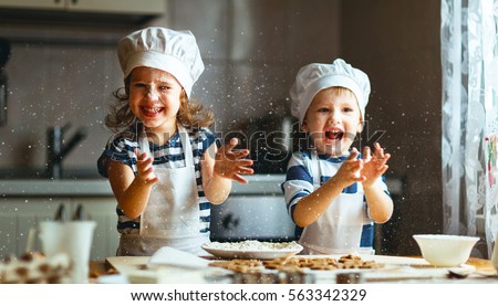 happy family funny kids are preparing the dough, bake cookies in the kitchen