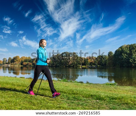 https://thumb7.shutterstock.com/display_pic_with_logo/88506/269216585/stock-photo-nordic-walking-adventure-and-exercising-young-woman-hiking-with-nordic-walking-poles-in-park-269216585.jpg