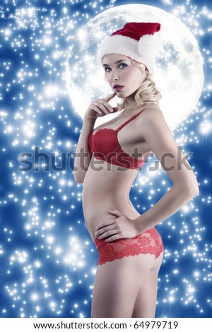 fashionb sexy shot of blond girl in red lingerie with christmas hat with sky on background