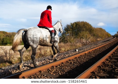 stock-photo-master-of-the-hunt-gallops-at-the-side-of-railway-lines-158265461.jpg