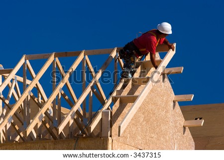 Carpenter building a house