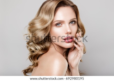 Beauty portrait of model with natural make-up. Fashion shiny highlighter on skin, sexy gloss lips make-up